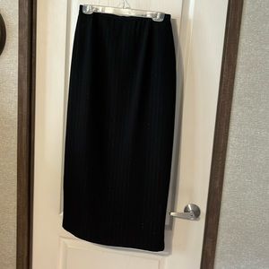 Straight black, pinstripe skirt, back zipper and back slit.
